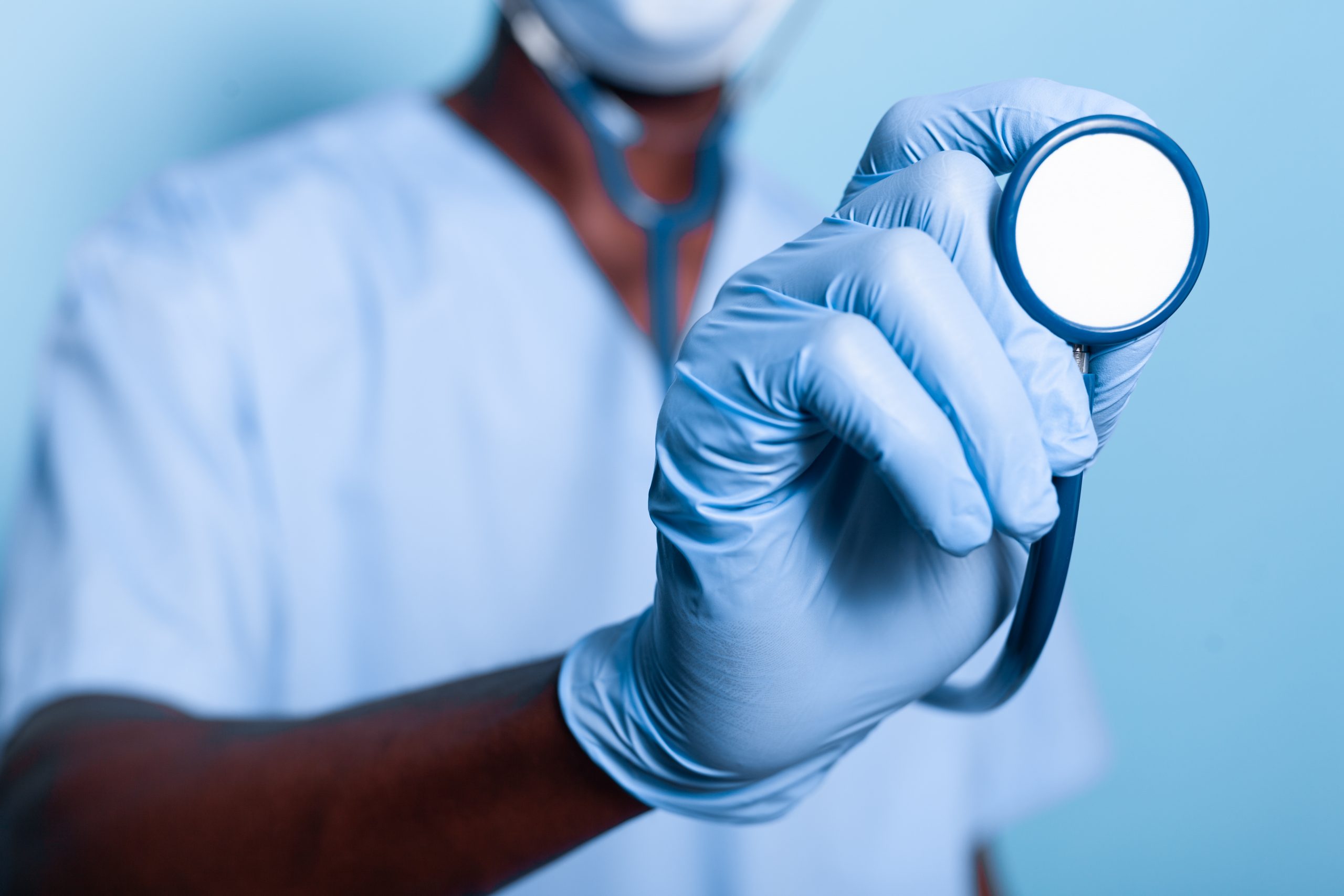 close up african american hand holding stethoscope scaled